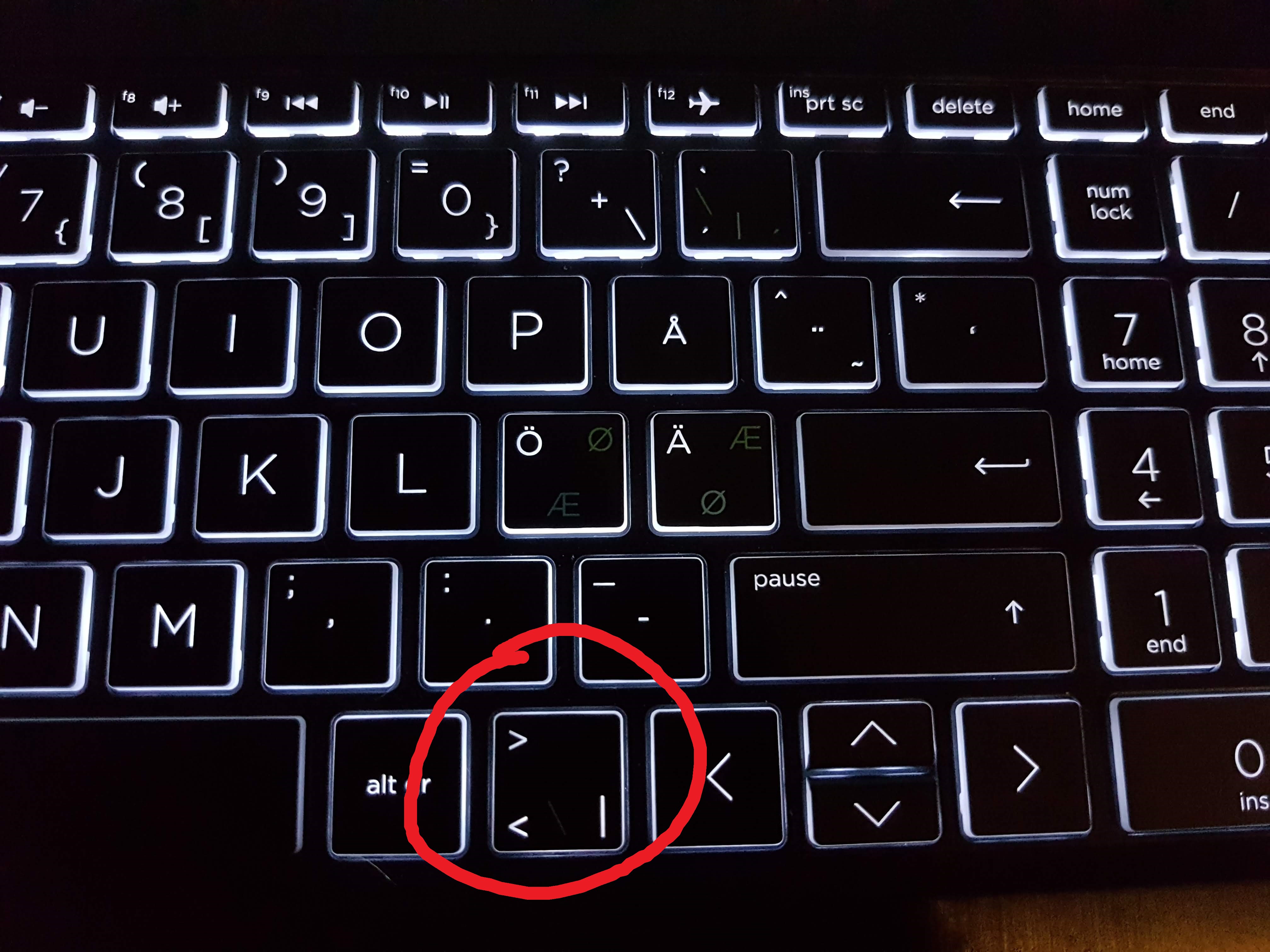 Solved: The greater than/less than signs "<" and ">" key replaced
