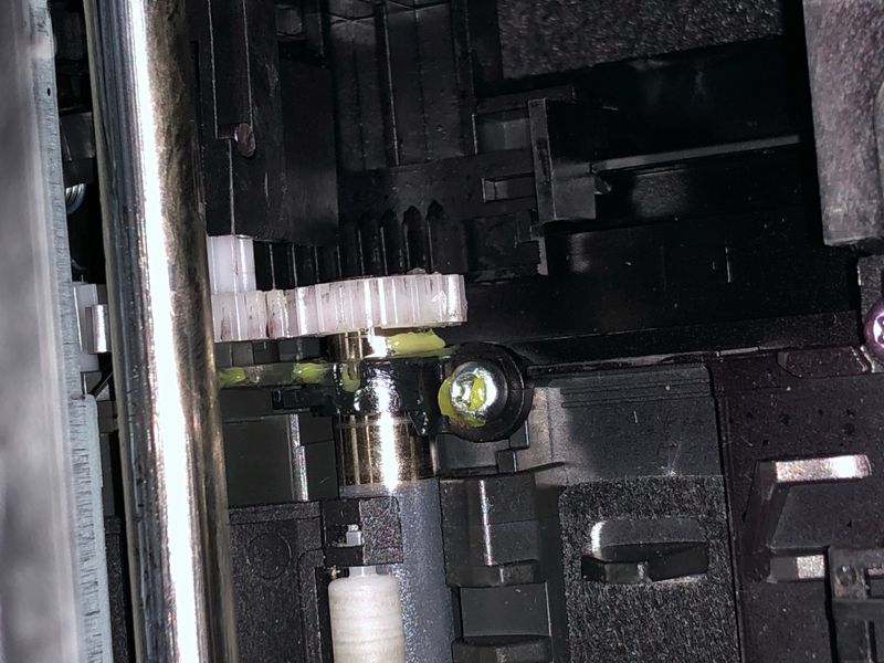 the gear slid back on the rod, back in place, doesn't move, and now the printer works again.
