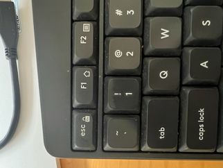 Keyboard with ESC+fn symbol displayed